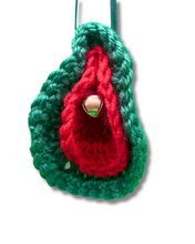 Load image into Gallery viewer, Crocheted ornament with red center and green border on a white background
